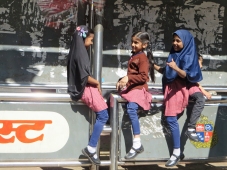 These little Muslim girls were playing at a bus stop.
